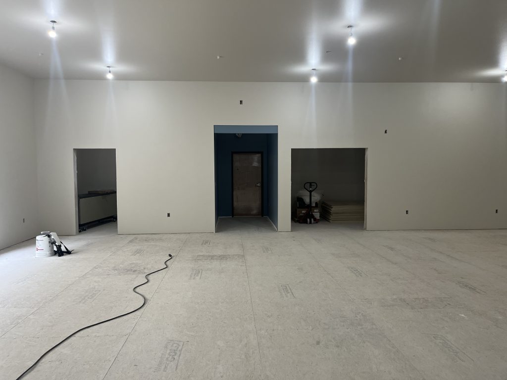 Empty room with three doors under construction