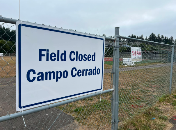 Field closed sign on a chain link fence