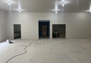 Empty room with three doors under construction