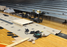 Metal bleachers installed with construction materials on the floor