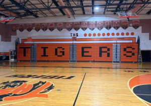 New orange bleachers pushed up against the wall with TIGERS spelled out